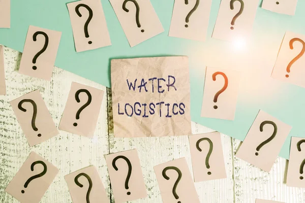 Handwriting text Water Logistics. Concept meaning the management of the flow of things from port to consumer Scribbled and crumbling papers with thick cardboard above wooden table.