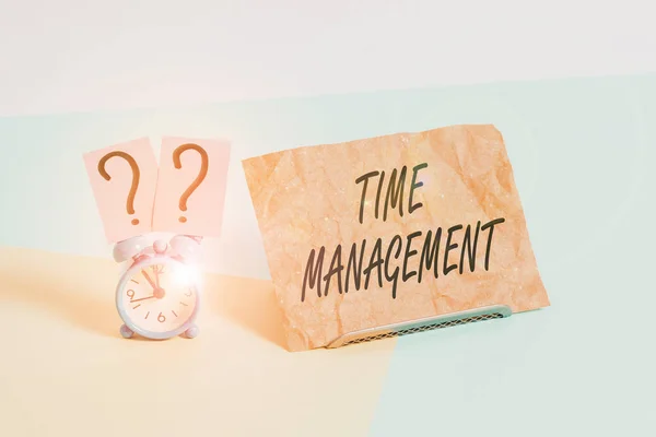 Word writing text Time Management. Business concept for the ability to use one time effectively or productively Mini size alarm clock beside a Paper sheet placed tilted on pastel backdrop. — Stockfoto
