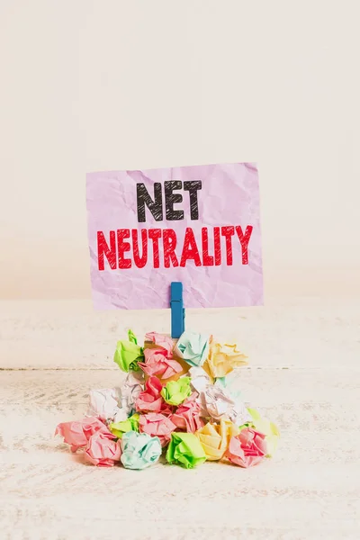 Writing note showing Net Neutrality. Business photo showcasing rules that ensured equal access to all websites Open Internet Reminder pile colored crumpled paper clothespin wooden space.