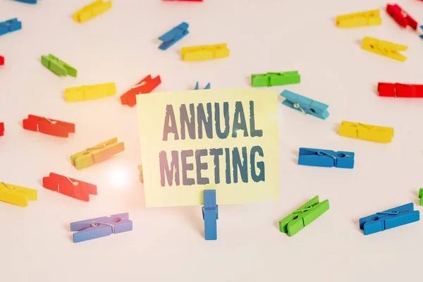 Word writing text Annual Meeting. Business concept for a meeting of the general membership of an organization Colored clothespin papers empty reminder white floor background office.