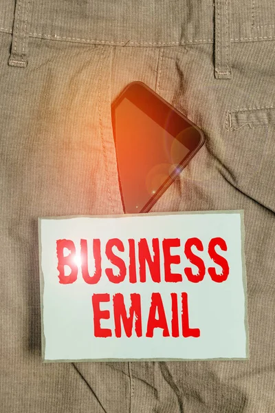 Handwriting text writing Business Email. Concept meaning the email which you use specifically for your business Smartphone device inside formal work trousers front pocket near note paper. — Stok fotoğraf