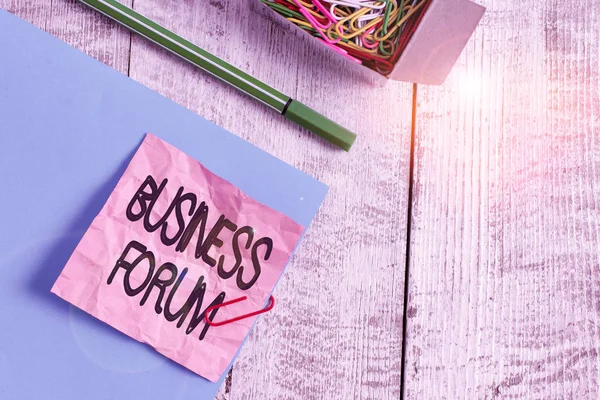 Writing note showing Business Forum. Business photo showcasing place in which showing exchange ideas and discuss issues Wrinkle paper and cardboard placed above wooden background.