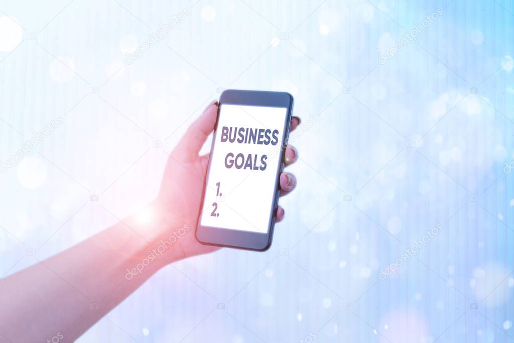 Writing note showing Business Goals. Business photo showcasing company expects to accomplish over a specific period of time.