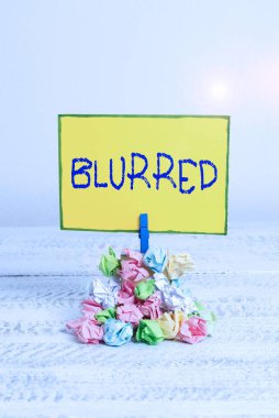 Writing note showing Blurred. Business photo showcasing cannot or unable to see clearly because it has no distinct outline Reminder pile colored crumpled paper clothespin wooden space.