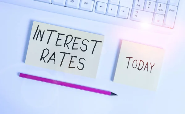 Conceptual hand writing showing Interest Rates. Business photo showcasing proportion of a loan charged as interest to the borrower Flat lay above copy space sticky notes with business concept. — Stock Photo, Image