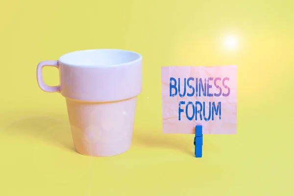 Text sign showing Business Forum. Conceptual photo place in which showing exchange ideas and discuss issues Cup empty paper blue clothespin rectangle shaped reminder yellow office.