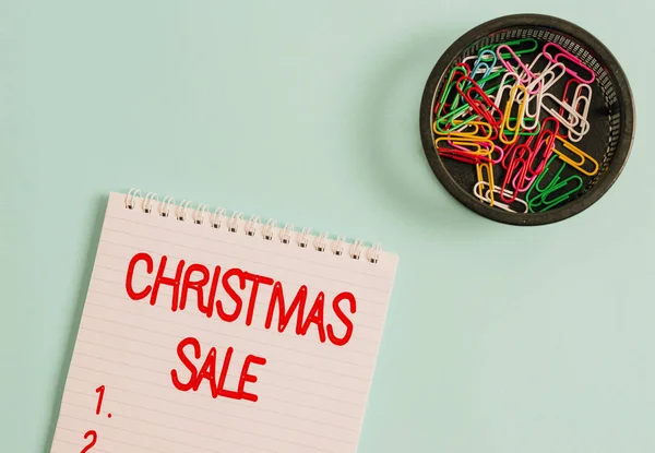 Conceptual hand writing showing Christmas Sale. Business photo text period during which a retailer sells goods at reduced prices Blank notebook and stationary placed above pastel colour backdrop. — 스톡 사진