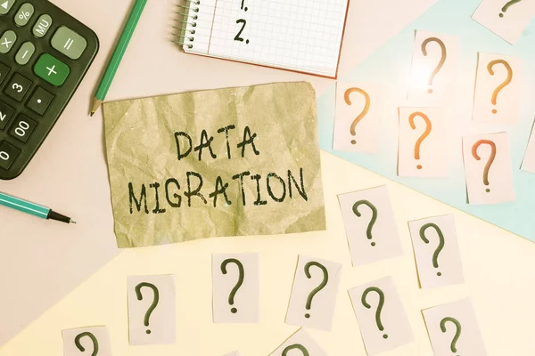 Word writing text Data Migration. Business concept for process of transferring data between data storage systems Mathematics stuff and writing equipment above pastel colours background.