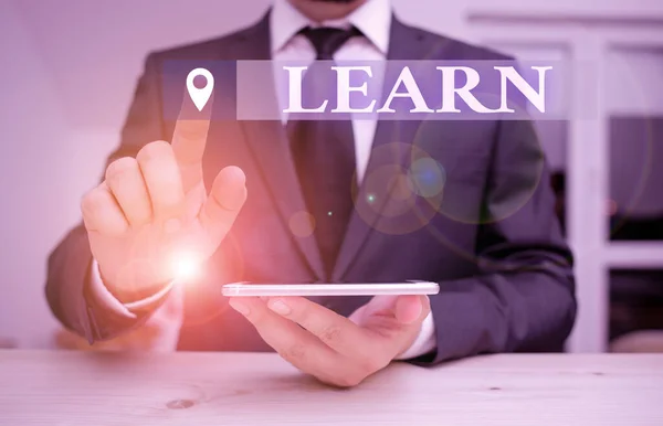 Handwriting text Learn. Concept meaning acquire knowledge of or skill in something by study or experience Male human wear formal clothes present presentation use hi tech smartphone. — Stock Photo, Image