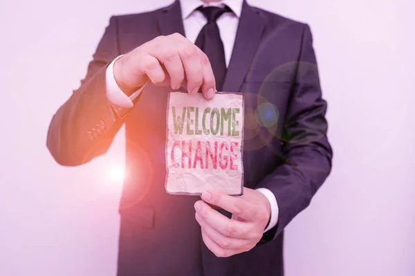 Handwriting text Welcome Change. Concept meaning to accept with pleasure the occurrence Longawaited change Male human wear formal work suit office look hold notepaper sheet use hand. — Stock Fotó