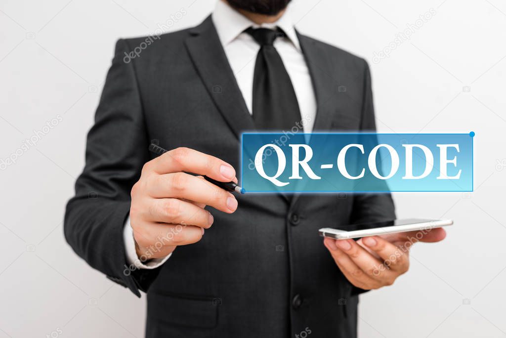 Handwriting text writing Qr Code. Concept meaning the trademark for a type of matrix barcode A machinereadable code Male human wear formal work suit hold smart hi tech smartphone use one hand.