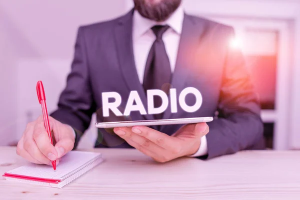 Word writing text Radio. Business concept for activity or industry of broadcasting sound programmes to the public Male human wear formal clothes present presentation use hi tech smartphone.