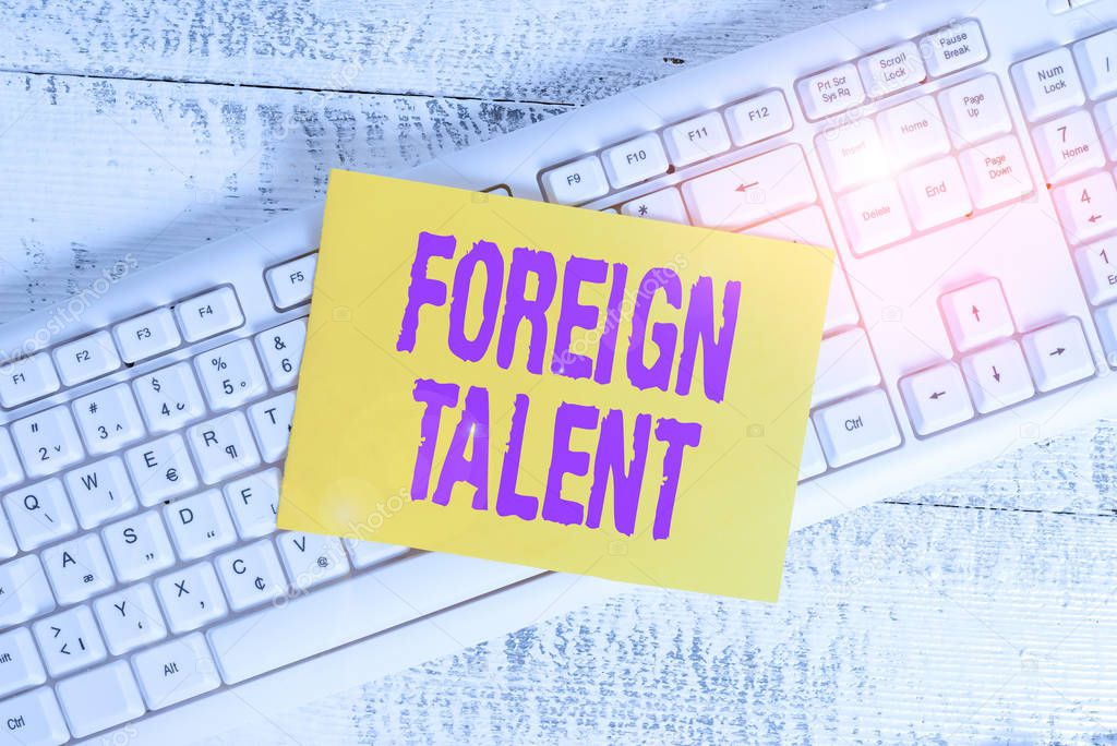 Handwriting text Foreign Talent. Concept meaning foreigners with professional qualifications or degrees White keyboard office supplies empty rectangle shaped paper reminder wood.