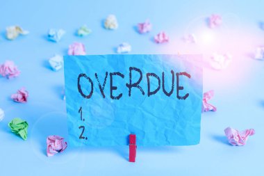 Handwriting text writing Overdue. Concept meaning loans and other obligations remaining unpaid past their due Colored crumpled rectangle shaped reminder paper light blue background. clipart