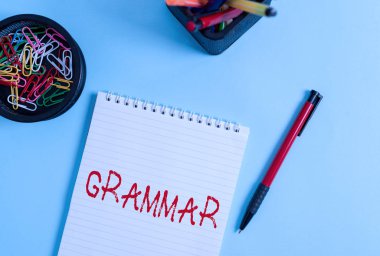 Word writing text Grammar. Business concept for whole system and structure of a language or languages in general Notebook and writing equipment with computer mouse above pastel backdrop.