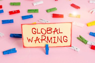 Handwriting text Global Warming. Concept meaning gradual increase in the temperature of the earth s is atmosphere Colored clothespin papers empty reminder pink floor background office pin.