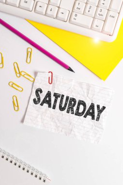 Word writing text Saturday. Business concept for First day of the weekend Relaxing time Vacation Leisure moment Flat lay above white blank paper with copy space for text messages.
