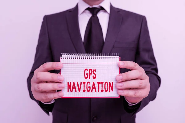 Text sign showing Gps Navigation. Conceptual photo the satellite infrastructure that enables navigation Male human wear formal work suit office look hold mathematics book use hand. — ストック写真