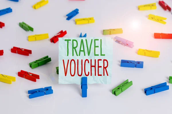 Handwriting text Travel Voucher. Concept meaning Tradable transaction type worth a certain monetary value Colored clothespin papers empty reminder white floor background office.