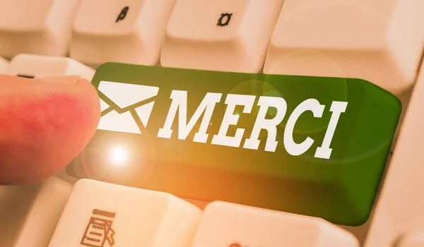 Writing note showing Merci. Business photo showcasing what is said or response when someone helps you in France Thank you. — Stockfoto