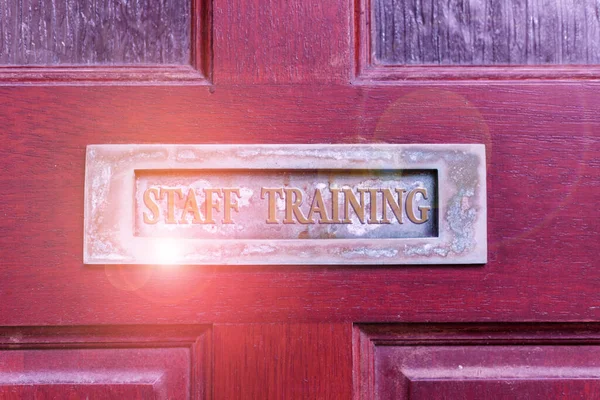Handwriting text writing Staff Training. Concept meaning program that is designed to increase the technical skills Old retro mailbox on the wooden doors. Hole on the wooden doors for mail.