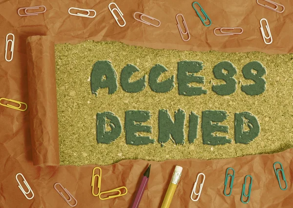 Writing note showing Access Denied. Business photo showcasing error message shown when you do not have access rights Stationary and torn cardboard on a wooden classic table backdrop.