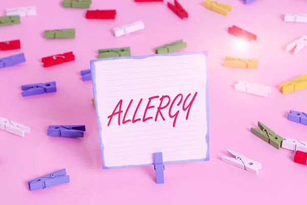 Conceptual hand writing showing Allergy. Business photo text Hypersensitive of the immune system towards particular substance Colored clothespin papers empty reminder pink floor office pin. — Stock Photo, Image