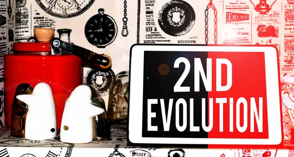 Text sign showing 2Nd Evolution. Conceptual photo change in the heritable features of biological populations Classic penguin ceramic and vintage teapot with modern gadget on display.