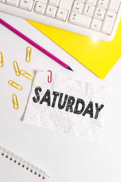 Word writing text Saturday. Business concept for First day of the weekend Relaxing time Vacation Leisure moment Flat lay above white blank paper with copy space for text messages. — Stock Fotó