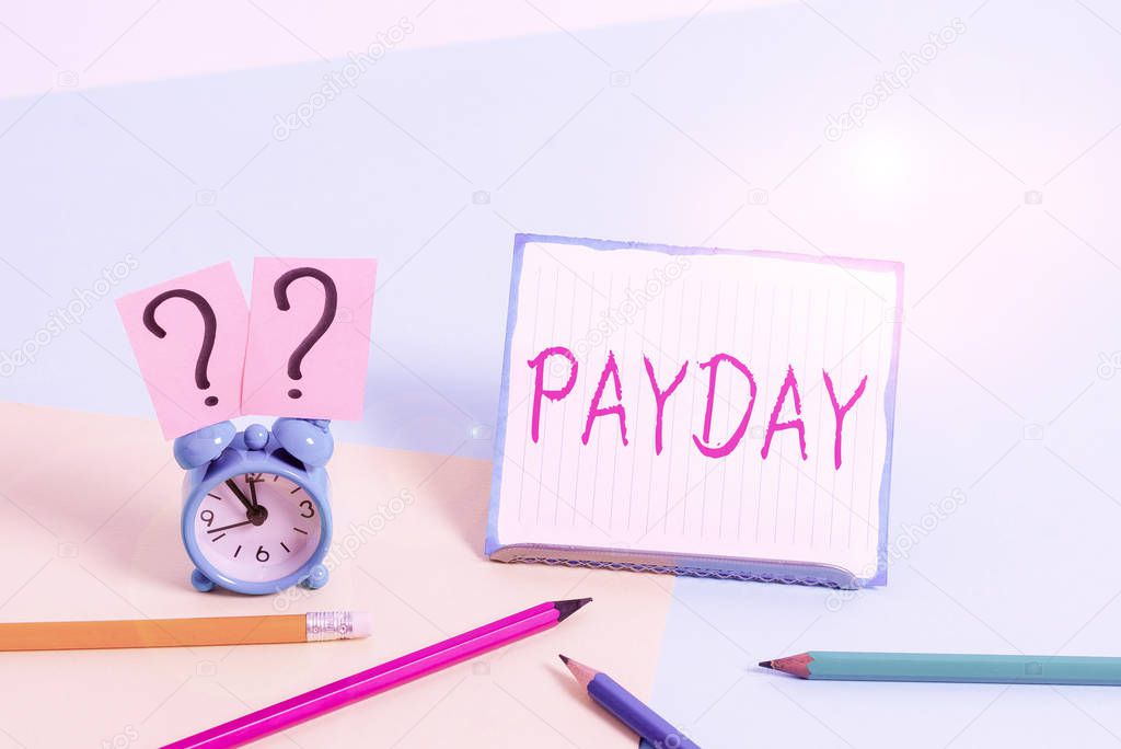 Word writing text Payday. Business concept for a day on which someone is paid or expects to be paid their wages Mini size alarm clock beside stationary placed tilted on pastel backdrop.