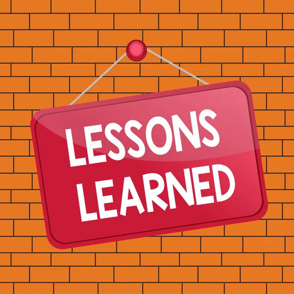 Text sign showing Lessons Learned. Conceptual photo the knowledge or understanding gained by experience Colored memo reminder empty board blank space attach background rectangle. — Stock Fotó