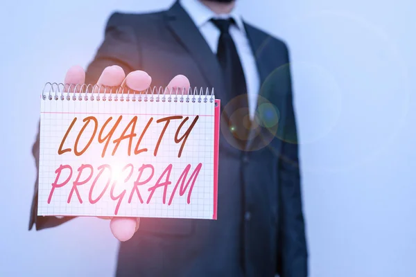 Text sign showing Loyalty Program. Conceptual photo marketing effort that provide incentives to repeat customers Male human wear formal work suit office look hold mathematics book use hand. — Stok fotoğraf