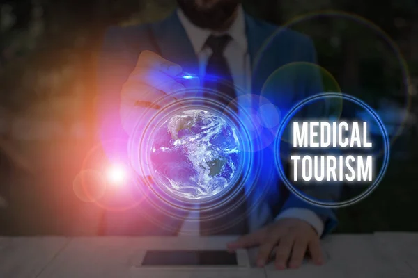 Writing note showing Medical Tourism. Business photo showcasing traveling outside the country to receive medical care Elements of this image furnished by NASA. — Stockfoto