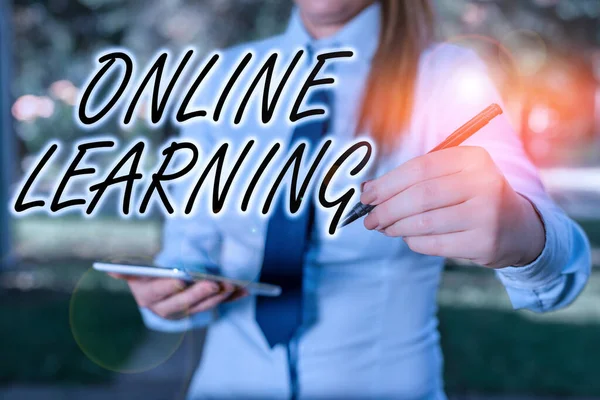 Handwriting text writing Online Learning. Concept meaning educational tool based on and accessible from the Internet Woman in a blue business shirts pointing with her finger into empty space. — Stock Fotó