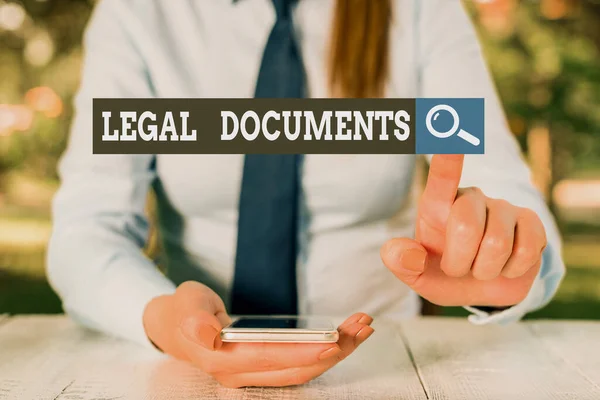 Text sign showing Legal Documents. Conceptual photo a document concerning a legal matter Drawn up by a lawyer Female business person sitting by table and holding mobile phone. — Stock Photo, Image