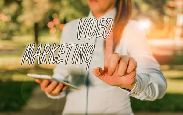 Text sign showing Video Marketing. Conceptual photo integrates engaging video into the marketing campaigns Woman in a blue business shirts pointing with her finger into empty space. — 스톡 사진