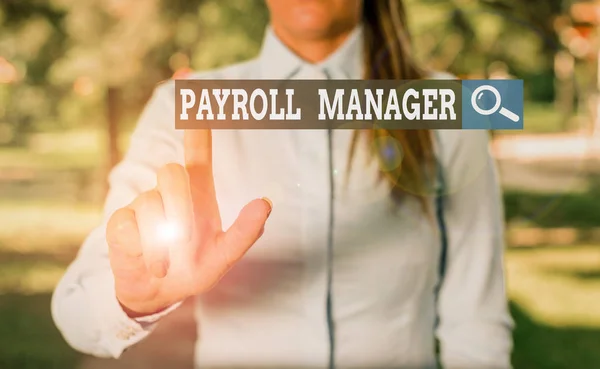 Writing note showing Payroll Manager. Business photo showcasing Maintains payroll information by designing systems Woman in a blue shirt pointing with her finger into empty space. — 图库照片