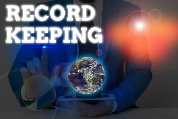 Writing note showing Record Keeping. Business photo showcasing The activity or occupation of keeping records or accounts Elements of this image furnished by NASA.