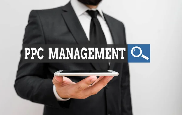 Conceptual hand writing showing Ppc Management. Business photo showcasing process of overseeing and analysisaging a company s is PPC ad spend Male human wear formal work suit hold smartphone using — Stockfoto