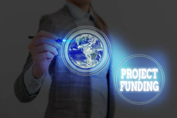 Writing note showing Project Funding. Business photo showcasing capital required to undertake a project or programme Elements of this image furnished by NASA. — Stock Photo, Image