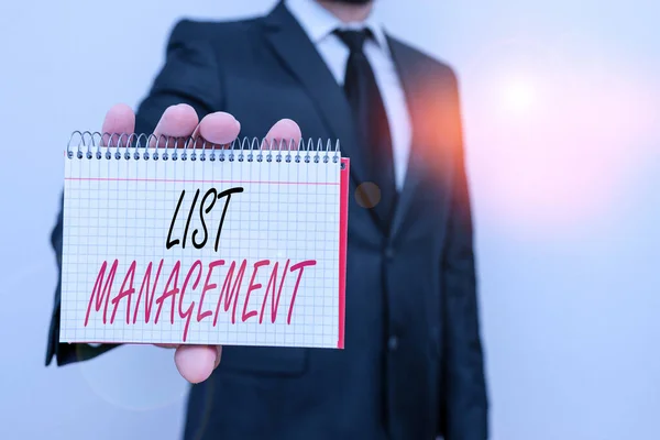 Text sign showing List Management. Conceptual photo company or individual who acts as an agent of the list owner Male human wear formal work suit office look hold mathematics book use hand. — Stock Photo, Image