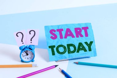 Word writing text Start Today. Business concept for to begin doing something Make something begin by doing something Mini size alarm clock beside stationary placed tilted on pastel backdrop.