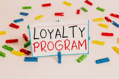 Text sign showing Loyalty Program. Conceptual photo marketing effort that provide incentives to repeat customers Colored clothespin papers empty reminder white floor background office.
