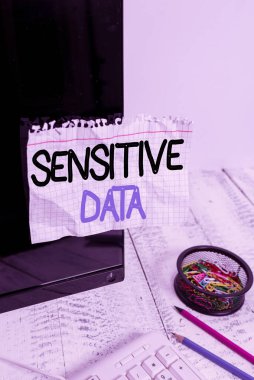 Word writing text Sensitive Data. Business concept for information that is protected against unwarranted disclosure Note paper taped to black computer screen near keyboard and stationary.