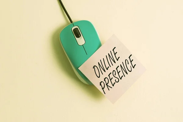 Conceptual hand writing showing Online Presence. Business photo text existence of an individual can be found via an online search Empty note paper stick to computer mouse above a pastel backdrop.