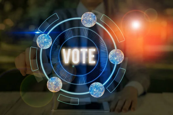 Handwriting text Vote. Concept meaning Act of expressing a formal indication of choice Majority wins Elements of this image furnished by NASA. — Stockfoto