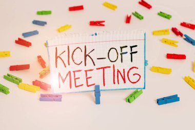 Text sign showing Kick Off Meeting. Conceptual photo first meeting with the project team and the client Colored clothespin papers empty reminder white floor background office. clipart
