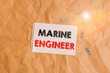 Conceptual hand writing showing Marine Engineer. Business photo showcasing incharge with maintenance and operation of a ship s is engines Papercraft desk square spiral notebook office study supplies.