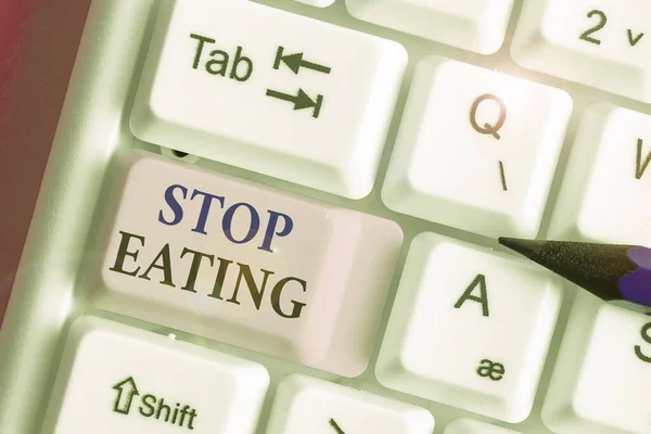 Writing note showing Stop Eating. Business photo showcasing cease the activity of putting or taking food into the mouth.