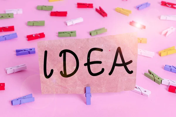 Conceptual hand writing showing Idea. Business photo text a thought or suggestion as to a possible course of action Suggestion Colored clothespin papers empty reminder pink floor office pin. — Stock Photo, Image